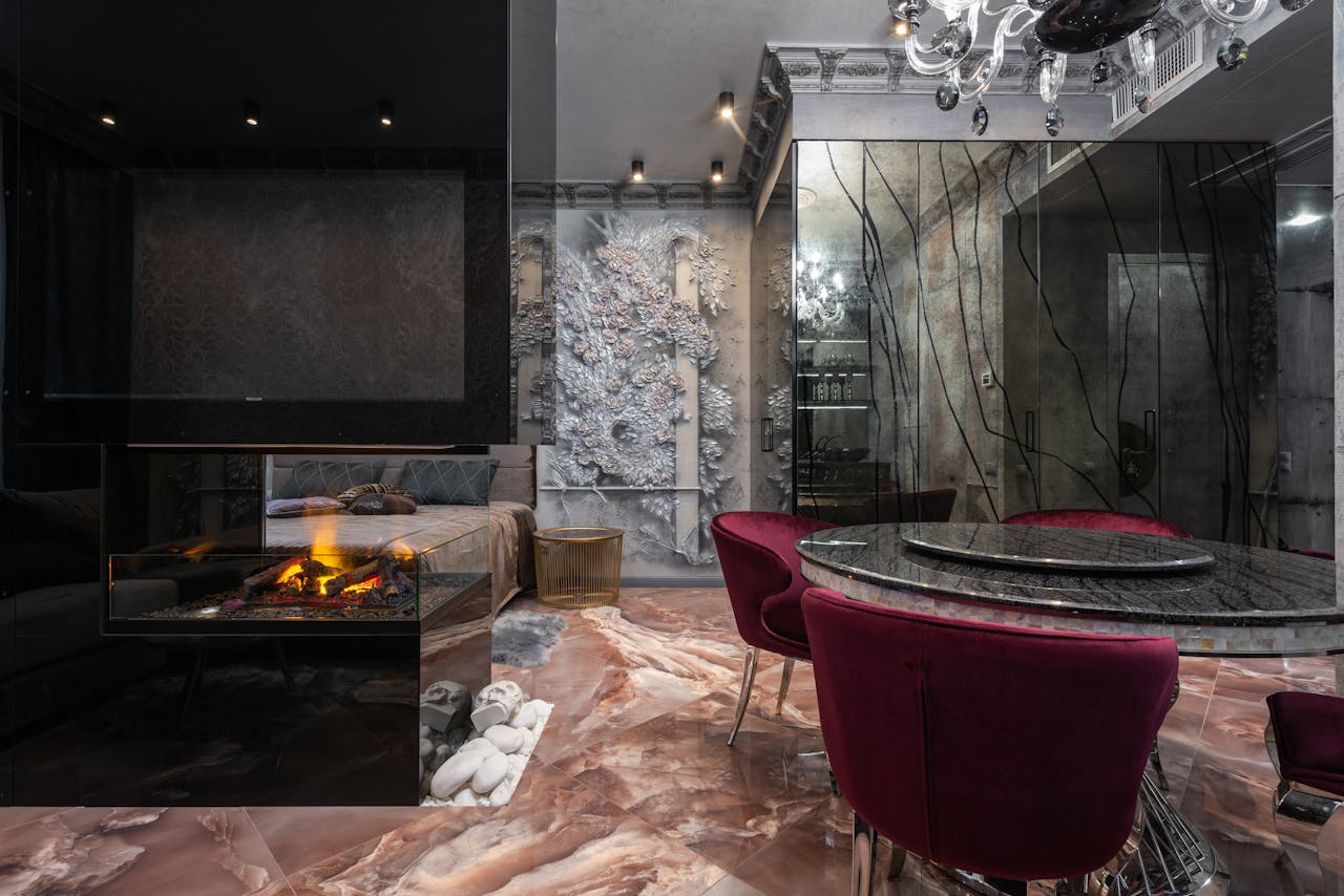 Stylish modern interior featuring a luxurious fireplace and elegant dining setup.